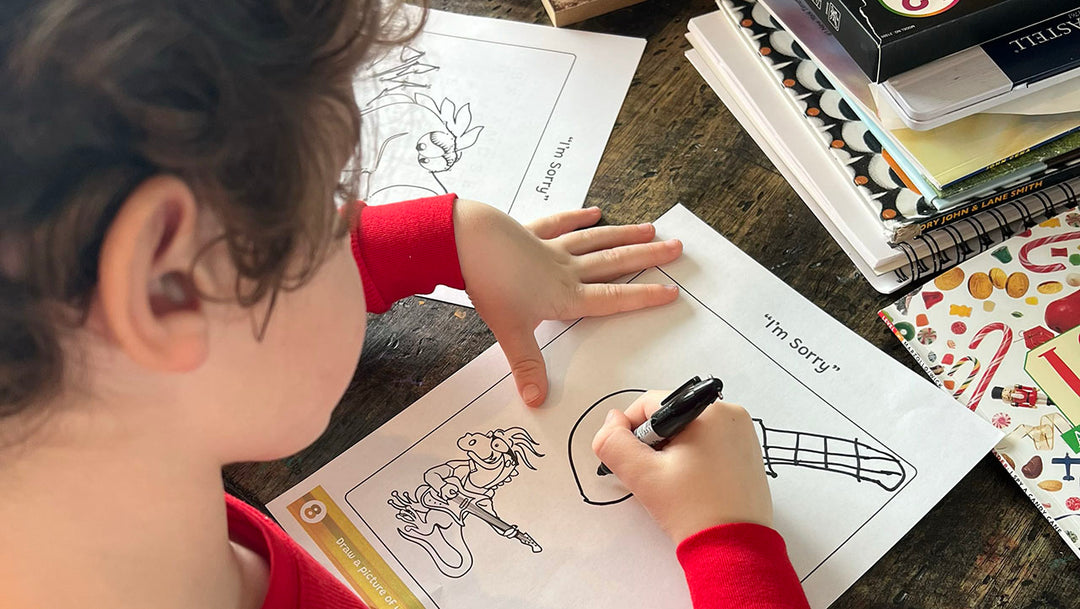 Young child drawing a picture of a guitar